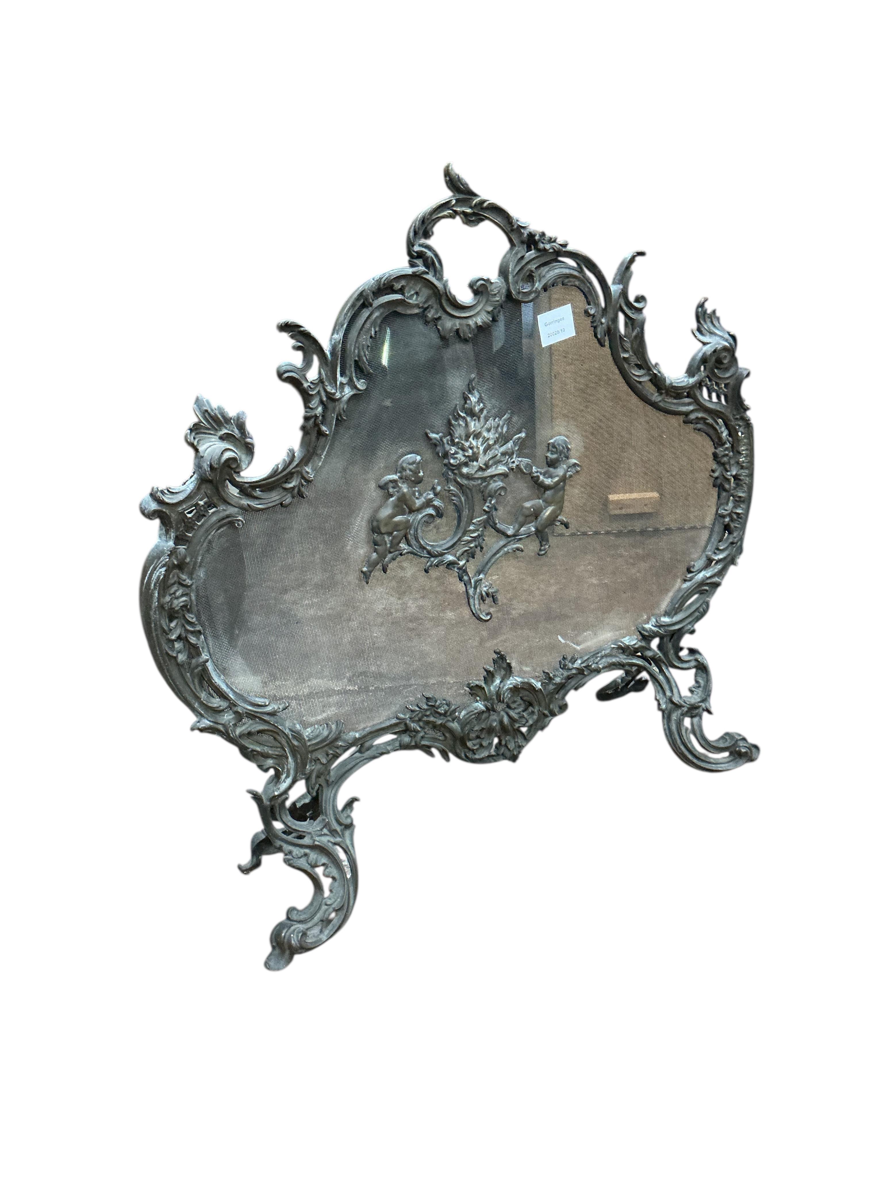 A late 19th century French rococo style cast brass mesh fire screen, width 72cm, height 70cm.